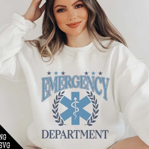 May include: White sweatshirt with a blue and gray graphic design that says "Emergency Department" with a star and medical symbol.