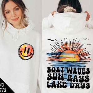 May include: White hoodie with a graphic of a sunset with the text "Boat Waves Sun Rays Lake Days" on the back and a smiley face on the front.