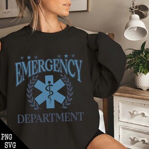 May include: Black sweatshirt with a blue and white graphic of a medical symbol and the text "EMERGENCY DEPARTMENT".
