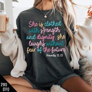 May include: A dark gray sweatshirt with a quote in colorful lettering that reads "She is clothed with strength and dignity, she laughs without fear of the future" and "Proverbs 31:25".