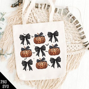 May include: A cream-colored tote bag featuring a repeating pattern of orange leopard-print pumpkins and black bows. Small black bats are scattered throughout the design. The bottom left corner of the bag has the text "PNG SVG".