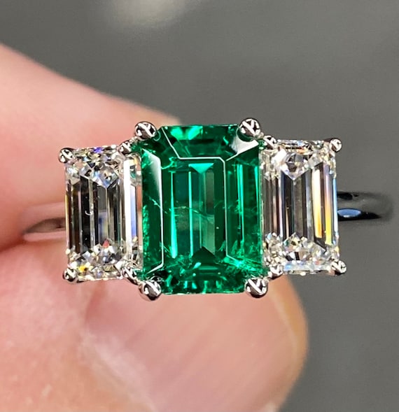 Platinum ring with green best sale stone