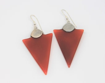 May include: A pair of silver earrings with red triangular carnelian stones.