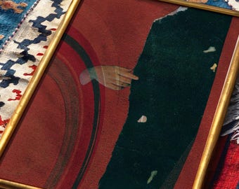 May include: A framed print featuring a stylized painting with a deep red background, a dark green vertical panel, and a hand reaching toward the center. The artwork includes concentric circular lines and is signed KLEE in the bottom right corner.