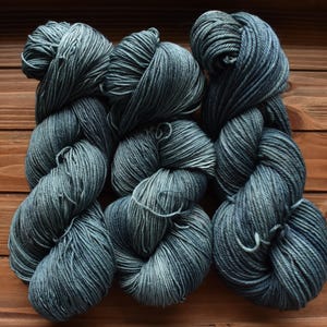 Blue Spruce: Grey Blue Green Hand-dyed, Merino Wool Yarn. Tonal green blue yarn. Pale Green, white, ochre spots. Semi-solid. Red specks.