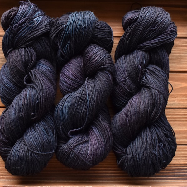 Midnight Road: Hand-Dyed Superwash Wool Fingering Sock Yarn. Tonal purple. Spruce green. Multicolored yarn. Dark purple. Dark teal.