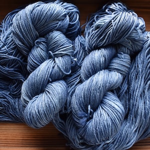 Denim: Denim blue Hand-dyed Wool Yarn. Tonal blue yarn.  Semi-solid yarn. Pale blue yarn. Pastel blue. Light blue. Pink and yellow Speckles.