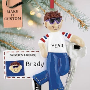 May include: A personalized Christmas ornament featuring a cartoon boy wearing sunglasses and holding a driver's license. The license says "DRIVER'S LICENSE" and "Brady". The ornament also includes the text "YEAR".
