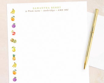 May include: White stationery set with a gold pen and envelope. The stationery features a border of watercolor fruit illustrations. The text "SAMANTHA BERRY" and address are printed in gold.