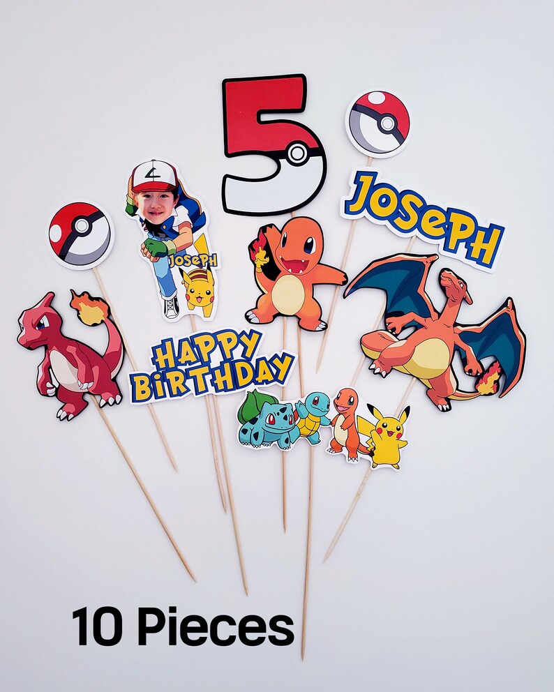 May include: Ten colorful Pokemon themed cake toppers with a red number 5, a character with a photo, a red and orange Pokemon, a blue and orange Pokemon, a yellow Pokemon, a green and brown Pokemon, a red and orange Pokemon, a red and orange Pokemon, a blue and yellow name banner that says "Joseph", and a yellow banner that says "Happy Birthday".