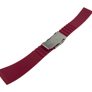 May include: A red silicone watch strap with a silver buckle.