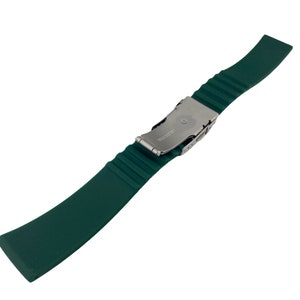 May include: A dark green silicone watch strap with a silver buckle. The buckle has the word "SWISS" engraved on it.