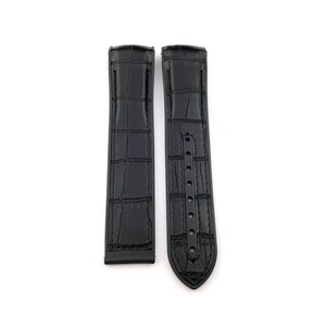 May include: A pair of black leather watch straps with a crocodile pattern. The straps have a buckle on one end and a pointed end on the other.