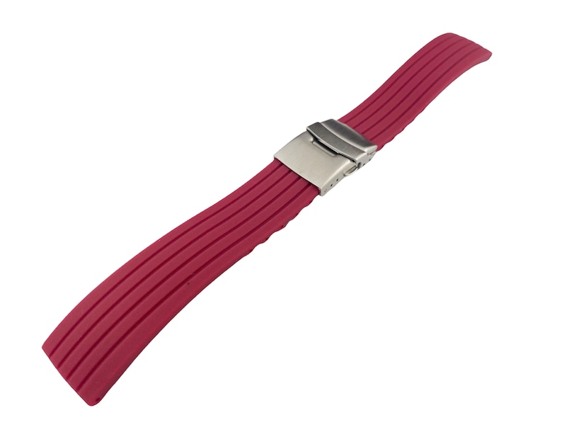 May include: A red silicone watch strap with a silver buckle.