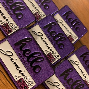May include: Purple glitter enamel pins with the text "hello my bias is Jimin" and a small musical note and a small image of a cookie.