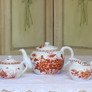 China Teapot, Milk Jug and Lidded Sugar Basin decorated in Chinese Style with Peonies, Song Birds and Butterflies