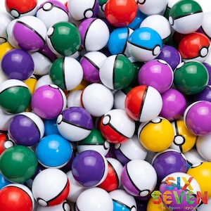 May include: A large collection of spherical plastic toys resembling Poke Balls in various colors including red, blue, green, purple, and yellow. Each ball features a white bottom half, a colored top half, and a black band with a central white button.