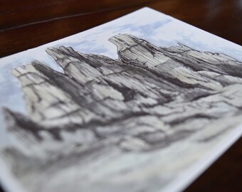 May include: A black and white watercolour painting of a mountain range with a light blue sky in the background.