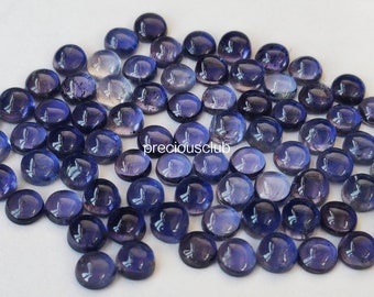 May include: A collection of 50 round, purple, faceted gemstones. The gemstones are approximately 6mm in diameter and have a smooth, polished finish.