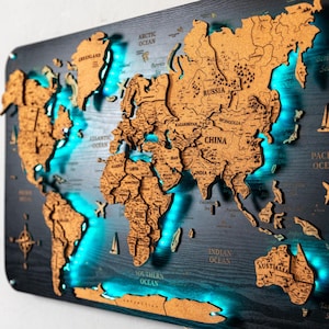 May include: A wooden world map with a dark blue background and light brown continents. The map is illuminated with blue LED lights around the continents. Decorative airplane and sailboat cutouts are included.