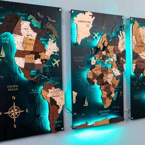 three wall-mounted world map panels, each depicting a different continent and country. The maps are illuminated with blue lighting, creating a visually striking and unique display.