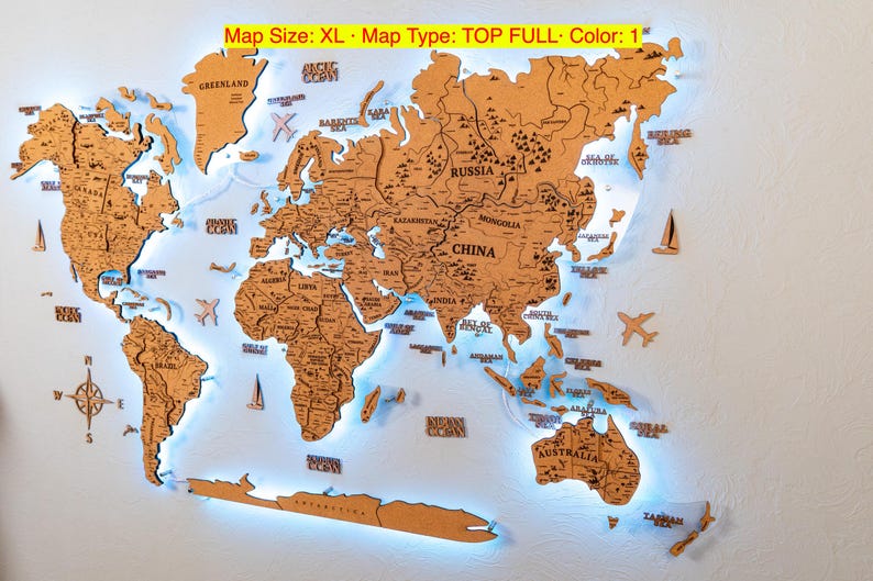A wooden world map with illuminated regions and countries, mounted on a wall.