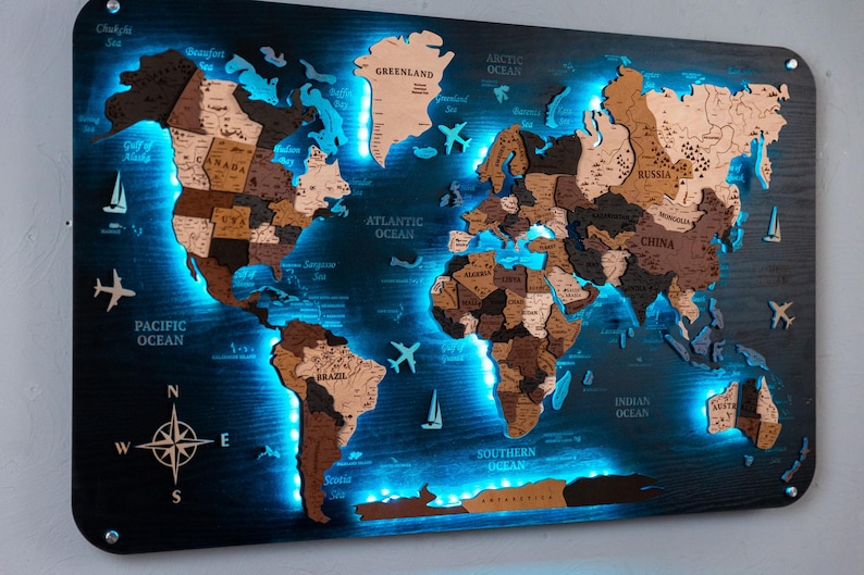 A wall-mounted world map with illuminated regions, likely representing different countries and their locations.