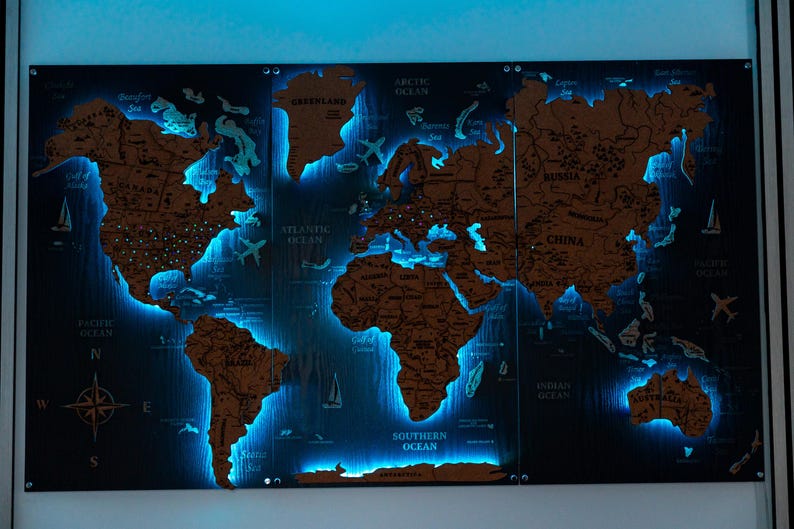 A large, illuminated world map with various countries and regions highlighted in blue light.