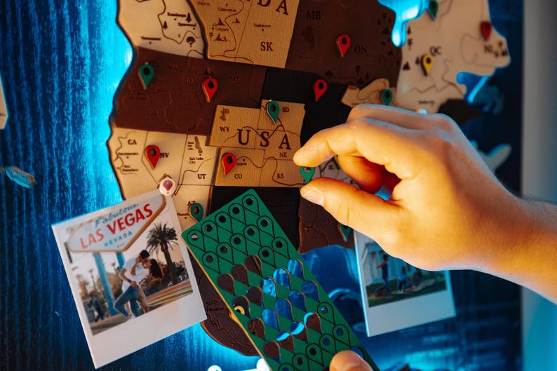A person's hand is holding a green and blue puzzle piece in front of a map of Las Vegas, with a photograph of a couple on the map.