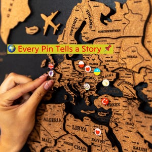 Carte du monde à épingles sur toile noire : organisateur de voyages en famille