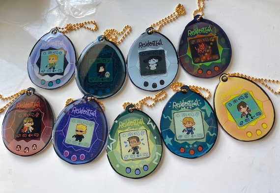 resident evil tamagotchi keychains abt 3” acrylic charms with epoxy on both sides! Ready to ship!
