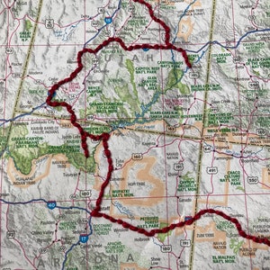 May include: A map of the southwestern United States with a red line outlining a road trip route. The route includes national parks such as Grand Canyon National Park, Zion National Park, Bryce Canyon National Park, Arches National Park, Canyonlands National Park, and Monument Valley.