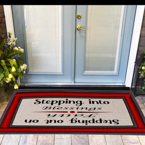 May include: A red and black doormat with the text "Stepping into blessings, Stepping out on faith".