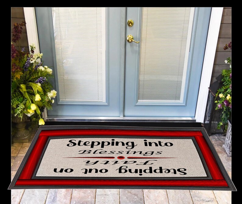 May include: A red and black doormat with the text "Stepping into blessings, Stepping out on faith".