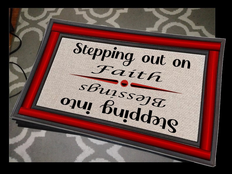May include: A black and red doormat with the text "Stepping into Blessings Stepping out on Faith" in white lettering.