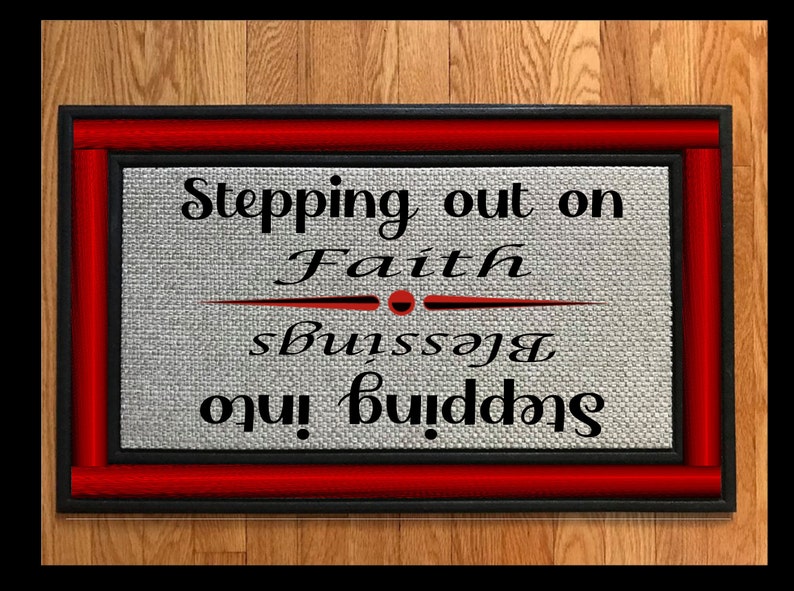 May include: A black and red doormat with the text "Stepping out on Faith, Stepping into Blessings".
