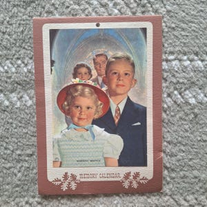 May include: A rectangular paper print titled MEMORY CALENDAR with the text MORNING SERVICE. The illustration depicts a young child in a red hat and light blue dress, a boy in a navy suit, and two adults in the background inside a church.