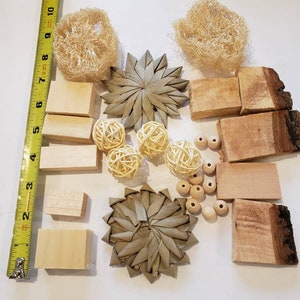 May include: A collection of natural chew toys for small animals, including wood blocks, woven palm leaf toys, and natural loofah.