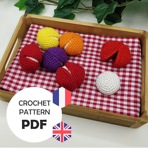 May include: A wooden tray with a red and white gingham cloth displays various colourful crocheted items. These include red, yellow, orange, purple, and white crocheted balls. The image also features the text "CROCHET PATTERN PDF" with the French and British flags.