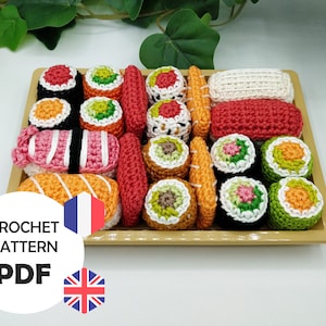 Peut inclure: Un ensemble de sushis en crochet dans un plateau en bois. L'ensemble comprend différents types de sushis, notamment des rouleaux de saumon, de thon et d'avocat. Les sushis sont faits avec des fils de différentes couleurs, notamment orange, rouge, vert et blanc.