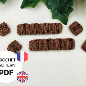 May include: Crochet pattern PDF for making a chocolate bar. The pattern includes instructions for making both the full-size bar and individual squares. The pattern is available in both English and French.