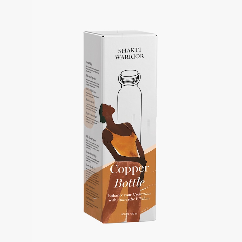 May include: A white box with a copper water bottle inside. The box has a brown illustration of a woman and the text "Shakti Warrior Copper Bottle Enhance your Hydration with Ayurvedic Wisdom 900 ml / 30 oz".