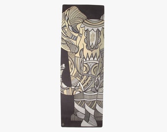 May include: A black yoga mat with a detailed illustration of an elephant in gold and gray tones.