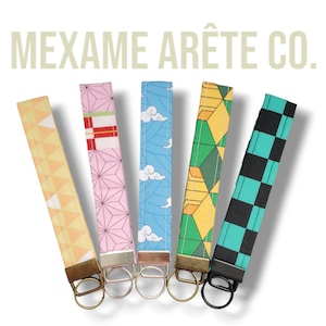 May include: Six colorful keychains with different patterns, including a checkered pattern, a geometric pattern, and a cloud pattern. Each keychain has a metal ring attached.