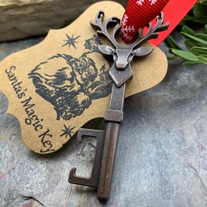 May include: A vintage-style key with a reindeer head design, attached to a brown paper tag that reads "Santa's Magic Key".