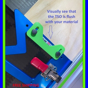 May include: A blue and green woodworking tool with a red clamp. The image includes the text "Visually see that the TSO is flush with your material".