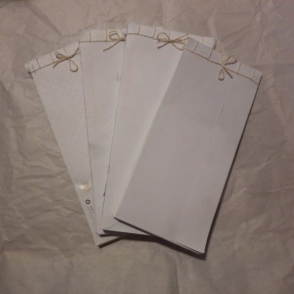 Upcycled stab-bound scratch pad / notepad / grocery list made from used envelopes