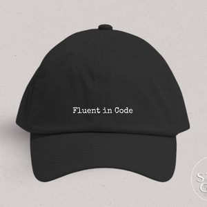 May include: Black baseball cap with the text "Fluent in Code" embroidered in white on the front.