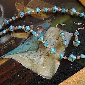 Handcrafted artisanal necklace/earring set  with variations of aqua in Czech bicone beads
