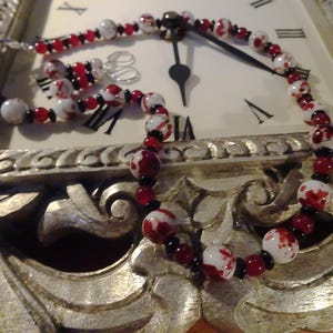 Handcrafted necklace/earring set with deep scarlet, white, and black coordinating elements